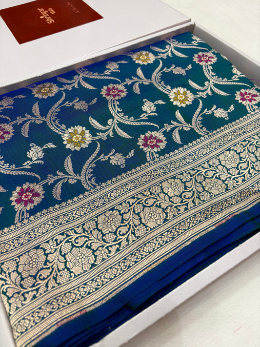 Blue saree with floral patterns on a white box