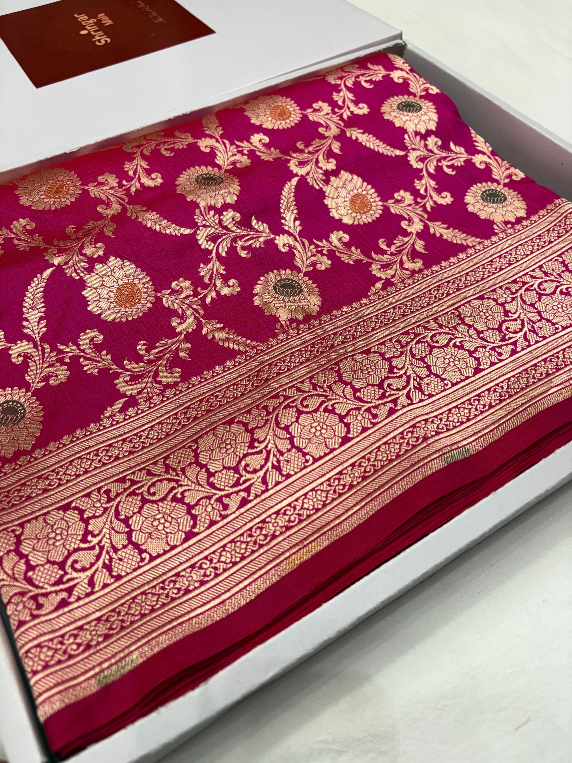 Decorative fabric with intricate gold patterns on a red background