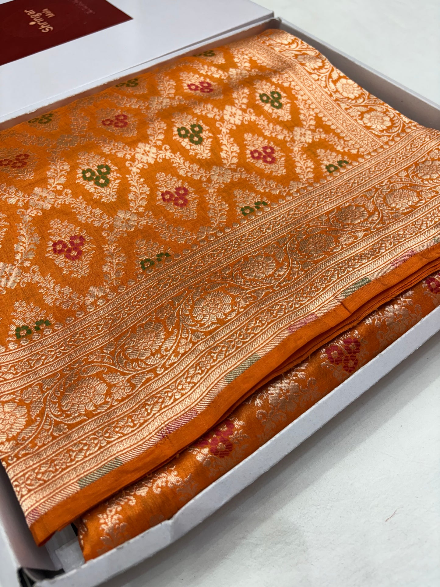 Ornate fabric with intricate patterns on a white background