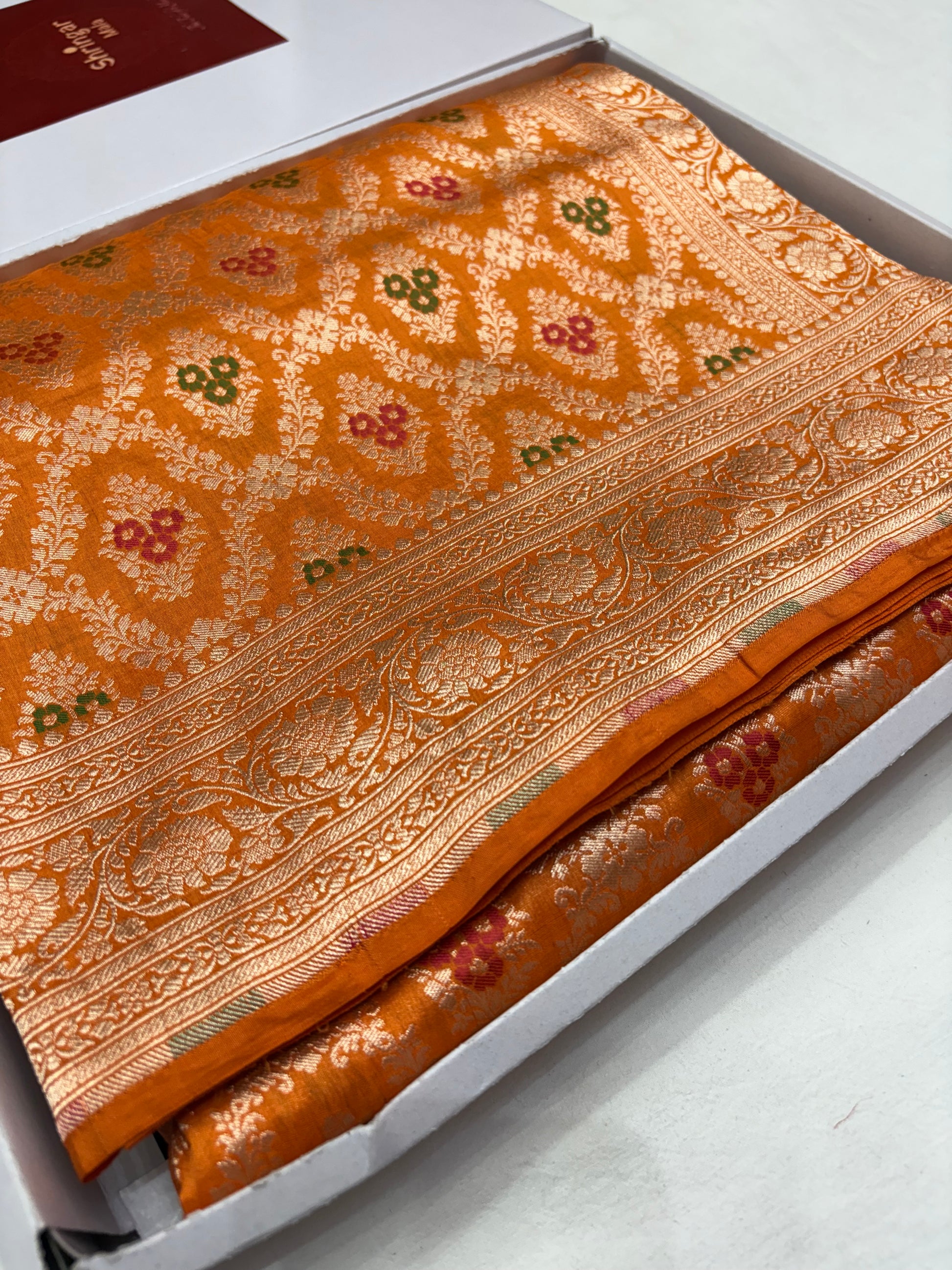 Ornate fabric with intricate patterns on a white background