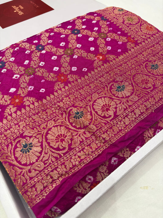 Purple fabric with gold and white floral patterns on a white background
