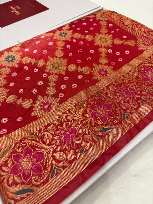 Red fabric with intricate floral patterns on a white background